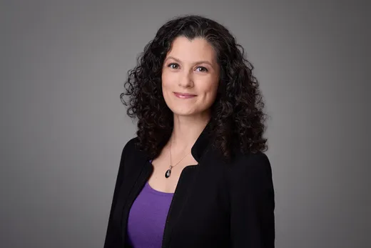 Samantha Spivey in a black blazer over a purple top, smiling
